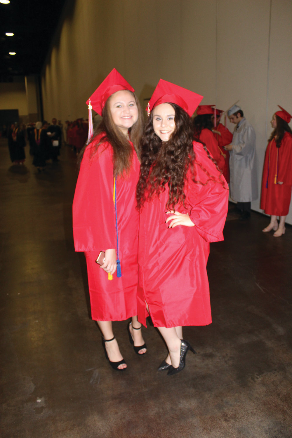 EXCITED FOR THE DAY: Seniors Emma Rosenfield and Emily Petrarca prepare for the procession into Saturday’s Cranston West graduation.